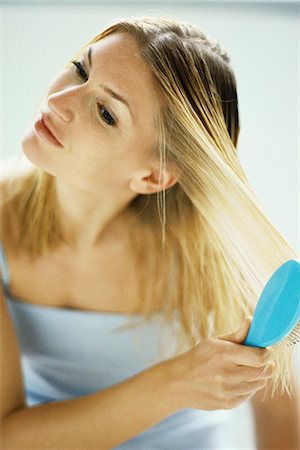 Woman brushing hair Stock Photo - Premium Royalty-Free, Code: 695-05769632