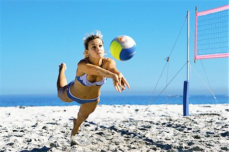 diving (not water) - Female playing beach volleyball diving to catch ball Stock Photo - Premium Royalty-Free, Code: 695-05769808