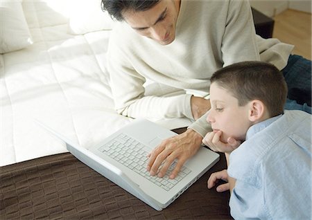 simsearch:695-05771662,k - Man and son using laptop Stock Photo - Premium Royalty-Free, Code: 695-05762508