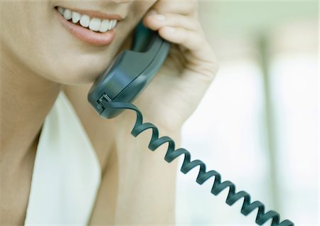 phone cord - Woman using landline phone Stock Photo - Premium Royalty-Free, Code: 695-05762746