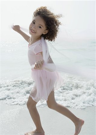 Girl playing on beach Stock Photo - Premium Royalty-Free, Code: 695-05762859