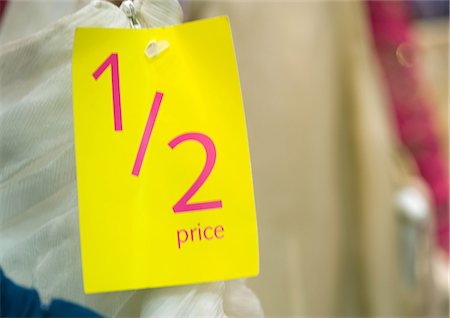 reduction - 1/2 price tag on clothing, close-up Stock Photo - Premium Royalty-Free, Code: 695-05762961