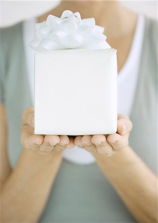 simsearch:622-06190925,k - Woman holding up present Stock Photo - Premium Royalty-Free, Code: 695-05763179