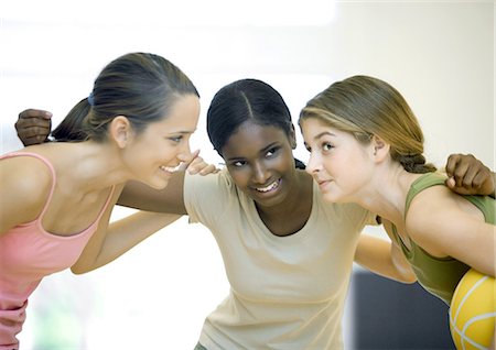 Teen girls huddling with basketball Stock Photo - Premium Royalty-Free, Code: 695-05763401