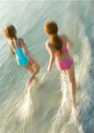 Two girls running in surf Stock Photo - Premium Royalty-Free, Code: 695-05763594