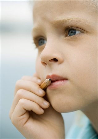 simsearch:695-03376367,k - Girl holding pencil next to mouth Stock Photo - Premium Royalty-Free, Code: 695-05763618