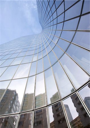 Skyscraper with reflection of buildings on facade, low angle, abstract view Stock Photo - Premium Royalty-Free, Code: 695-05763988