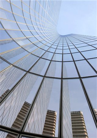 Skyscraper with reflection of buildings on facade, low angle, abstract view Stock Photo - Premium Royalty-Free, Code: 695-05763992