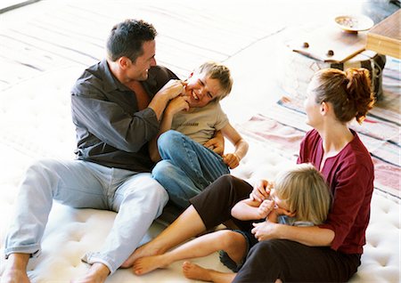 daddy tickling daughter - Parents and children playing on mattress Stock Photo - Premium Royalty-Free, Code: 695-05774000