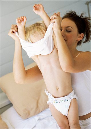 Mother undressing baby Stock Photo - Premium Royalty-Free, Code: 695-05774032