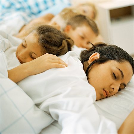 Young people lying in bed, sleeping Stock Photo - Premium Royalty-Free, Code: 695-05774123