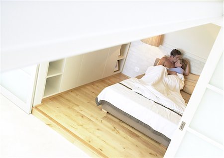 Couple in bed, embracing, high angle view Stock Photo - Premium Royalty-Free, Code: 695-05774169