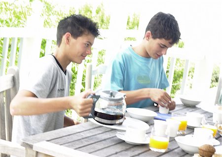 fraternization - Two teenage boys having breakfast outside Stock Photo - Premium Royalty-Free, Code: 695-05774184