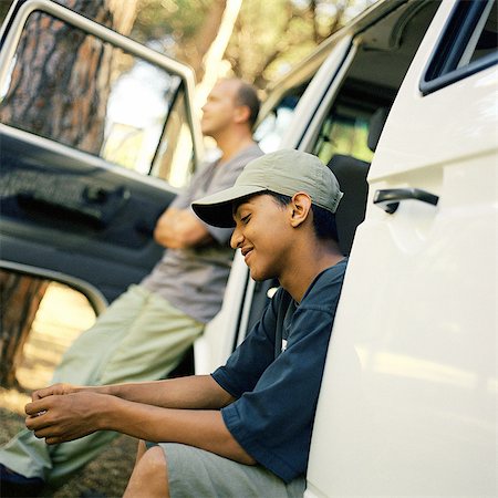 Man and teenage boy waiting at van with open doors Stock Photo - Premium Royalty-Free, Code: 695-05774512