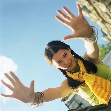 Teenage girl with both hands out, portrait Stock Photo - Premium Royalty-Free, Code: 695-05774806