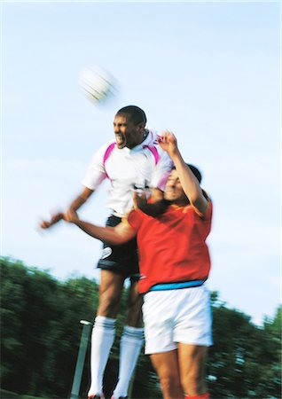recreational sports league - Two players jumping for ball at soccer match, blurred motion. Stock Photo - Premium Royalty-Free, Code: 695-05775801