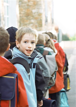school kids in line outside - Children in single file, one looking back, portrait Stock Photo - Premium Royalty-Free, Code: 695-05776458