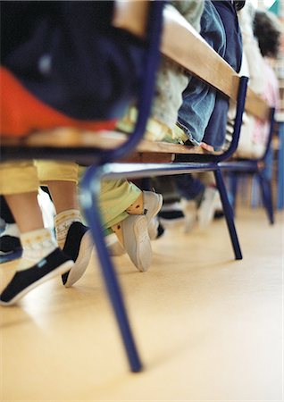 Children in classroom, low section, blurred Stock Photo - Premium Royalty-Free, Code: 695-05776481