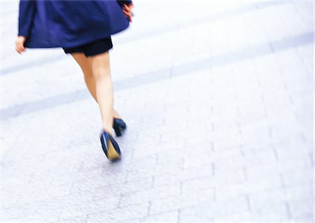 simsearch:695-03378125,k - Businesswoman walking, low section, tilt, blurred motion Stock Photo - Premium Royalty-Free, Code: 695-05776503