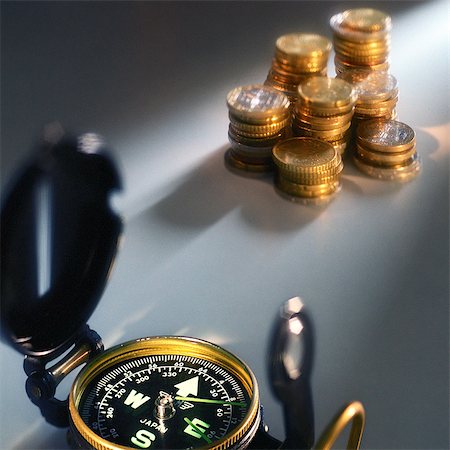 Compass near stacks of coins Stock Photo - Premium Royalty-Free, Code: 695-05776615