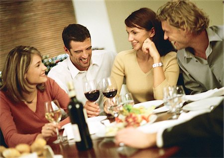 Group of young people around table, drinking wine and laughing Stock Photo - Premium Royalty-Free, Code: 695-05776633