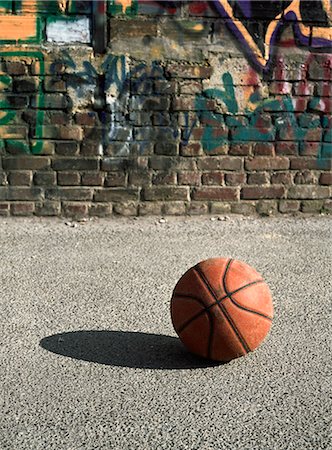 simsearch:632-06317210,k - Basketball on ground next to graffitied wall Foto de stock - Sin royalties Premium, Código: 695-05776778