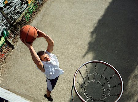 Man going up for a basketball dunk, shot from above Stock Photo - Premium Royalty-Free, Code: 695-05776781