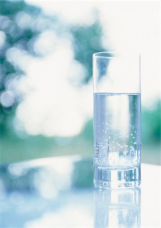 Glass of water on table Stock Photo - Premium Royalty-Free, Code: 695-05776890