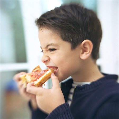 Boy eating slice of bread and jam, portrait Stock Photo - Premium Royalty-Free, Code: 695-05777048