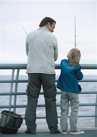 Man and son fishing on pier, rear view Stock Photo - Premium Royalty-Free, Code: 695-05777417