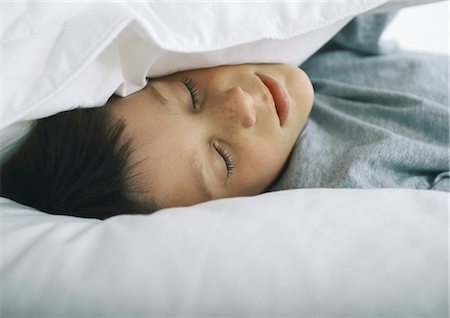 simsearch:693-03707745,k - Boy lying with head in pillows Stock Photo - Premium Royalty-Free, Code: 695-05777637