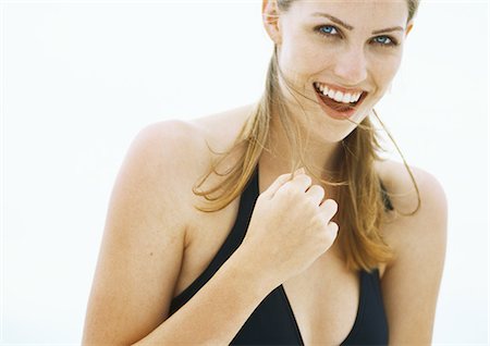 Young woman in bathing suit smiling, head and shoulders Stock Photo - Premium Royalty-Free, Code: 695-05777870