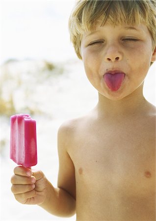 Little boy with popsicle, sticking tongue out with eyes closed Stock Photo - Premium Royalty-Free, Code: 695-05777917