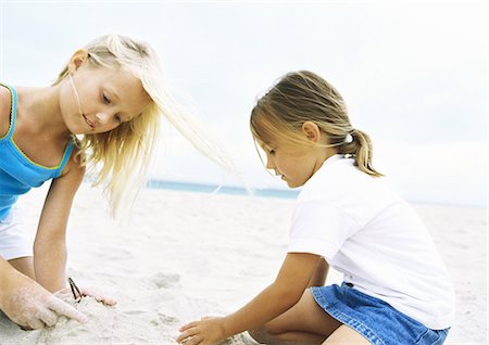 Two girls playing in sand Stock Photo - Premium Royalty-Free, Code: 695-05777912