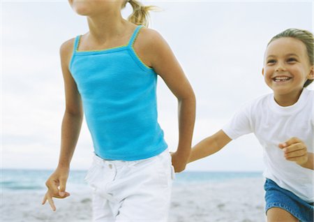 Two little girls, hand in hand on beach Stock Photo - Premium Royalty-Free, Code: 695-05777921