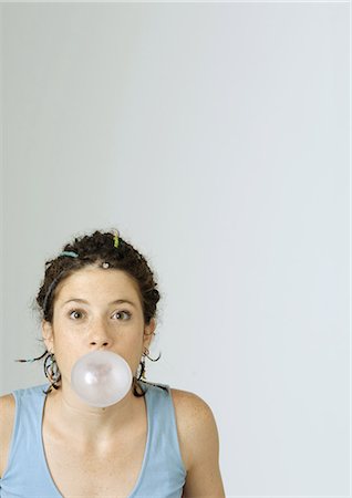 Young woman blowing bubble gum bubble, portrait Stock Photo - Premium Royalty-Free, Code: 695-05778487