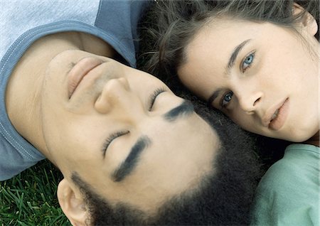 simsearch:695-05767104,k - Young couple lying on grass together, close-up Stock Photo - Premium Royalty-Free, Code: 695-05778547