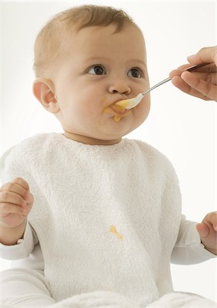 Baby being fed baby food Stock Photo - Premium Royalty-Free, Code: 695-05778622