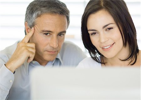 face to internet technology - Man and woman using computer Stock Photo - Premium Royalty-Free, Code: 695-05778838