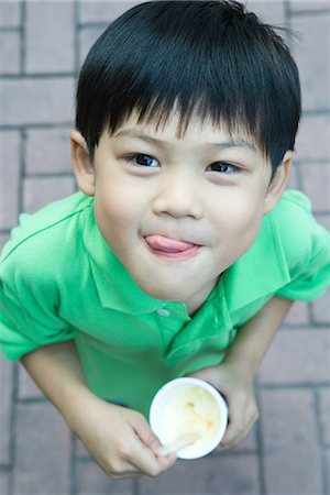 Boy eating ice cream, licking lips Stock Photo - Premium Royalty-Free, Code: 695-05779084