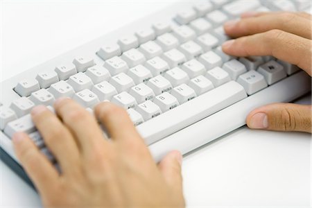 Hands typing on computer keyboard Stock Photo - Premium Royalty-Free, Code: 695-05779374