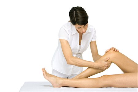 Woman giving leg massage, cropped view of legs Stock Photo - Premium Royalty-Free, Code: 695-05779431