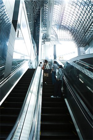 People going up escalator, rear view Stock Photo - Premium Royalty-Free, Code: 695-05779599