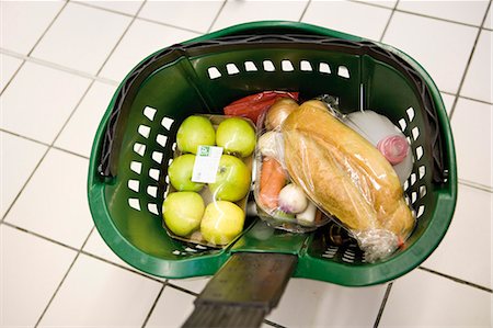 shopping in vegetable & fruits - Shopping basket containing groceries Stock Photo - Premium Royalty-Free, Code: 695-05779961