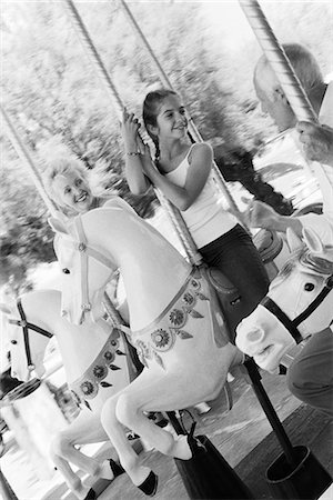 europe theme park - Girl riding carousel with her grandparents Stock Photo - Premium Royalty-Free, Code: 695-05770041