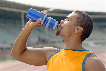 Athletic man drinking water from bottle Stock Photo - Premium Royalty-Free, Code: 695-05770077