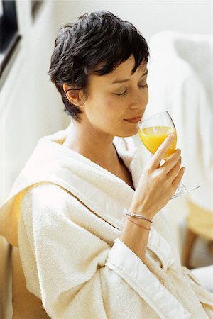 savor food - Woman in bathrobe drinking orange juice Stock Photo - Premium Royalty-Free, Code: 695-05770112