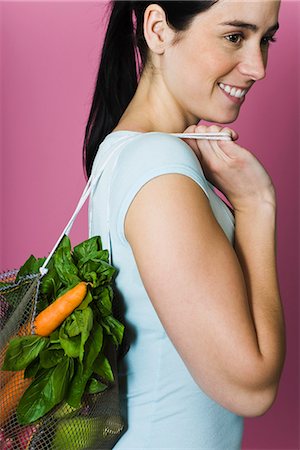 shopping in vegetable & fruits - Young woman with sack of fresh vegetables carried over shoulder Stock Photo - Premium Royalty-Free, Code: 695-05770299