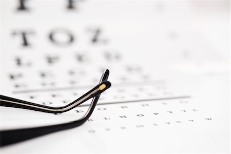 eye exam - Glasses on eye chart, cropped Stock Photo - Premium Royalty-Free, Code: 695-05770663