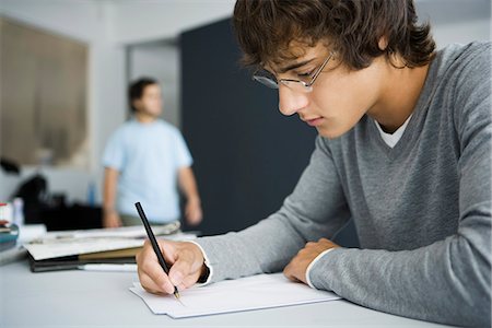 student (male) - College student writing at desk in classroom Stock Photo - Premium Royalty-Free, Code: 695-05770797